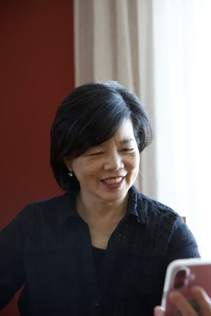 A woman smiling on a Twos video call