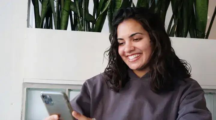 A woman laughing during a Twos conversation